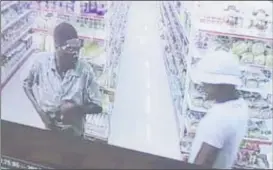  ??  ?? A still from the surveillan­ce footage showing the two suspects who carried out the robbery