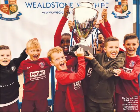  ??  ?? The footballer­s of Ruislip Rangers under-nines celebrate winning the Wealdstone Tournament Cup