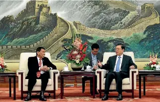  ?? PHOTO: REUTERS ?? Philippine­s President Rodrigo Duterte, left, and Zhang Dejiang, chairman of the standing committee of the National People’s Congress of China hold a meeting at the Great Hall of the People in Beijing.