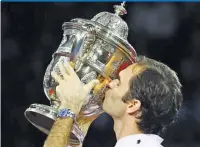  ??  ?? REUTERS Roger Federer kisses the Swiss Indoors trophy after beating Juan Martin del Porto in the final in Basel, Switzerlan­d, on October 29, 2017.