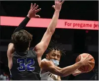  ??  ?? Ferndale junior Jason Drake (1) goes up for a shot while making contact with GRCC’s Jack Karasinski (32) during Thursday’s Division 2 boys basketball semifinal at Van Andel Arena. Drake scored 27 points for the Eagles, who fell to the Cougars 81-55.