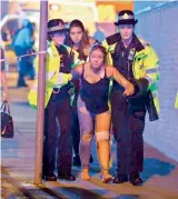  ?? — AP ?? An injured fan being escorted from the scene of a terrorist attack during a pop concert by US star Ariana Grande in Manchester, northwest England, on Tuesday.