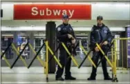  ?? THE ASSOCIATED PRESS ?? Police stand guard inside the Port Authority Bus Terminal following an explosion near Times Square on Monday.