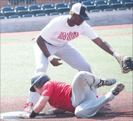  ?? RICK PECK/SPECIAL TO MCDONALD COUNTY PRESS ?? McDonald County’s Cole Martin beats a pick-off throw at first base during the McDonald County 18U baseball team’s 7-6 win over Oklahoma Red Dirt on July 20 in the Joplin 18U Baseball Showcase Tournament.