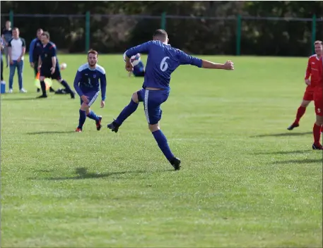  ??  ?? Robbie Eyre scores Ashford’s third goal of the afternoon.