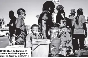  ?? AP/JEROME DELAY ?? RESIDENTS of the township of Soweto, South Africa, queue for water on March 16.