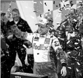  ?? ORLIN WAGNER/AP ?? Denny Hamlin celebrates after winning the NASCAR Cup playoff race Sunday at Kansas Speedway.