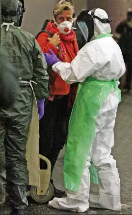  ??  ?? Patient: The masked woman arrives at Aberdeen Royal Infirmary