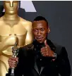  ??  ?? Mahershala Ali holds up his Oscar for Best Supporting Actor