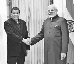  ??  ?? Modi (right) shakes hands with Duterte ahead of a meeting on the sidelines of Asean-India Commemorat­ive Summit in New Delhi. — AFP photo