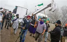  ?? ALTAF QADRI / ASSOCIATED PRESS ?? Indian farmers who have been protesting for a week to demand guaranteed crop prices wait to march to the capital on Wednesday.