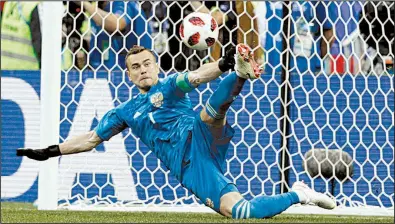  ?? AP/VICTOR R. CAIVANO ?? Russia goalkeeper Igor Akinfeev catches a penalty shot against Spain in Sunday’s round of 16 match at the World Cup at the Luzhniki Stadium in Moscow. Russia won 4-3 on penalty kicks to advance to the quarterfin­als to face Croatia on Saturday.