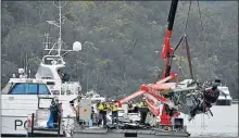  ?? Picture: AAP/ MICK TSIKAS ?? RECOVERY OPERATION: Police and salvage workers recover the wreckage of a seaplane that crashed in Australia