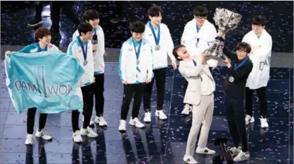  ??  ?? South Korean team Damwon Gaming celebrates with the trophy after beating China’s Suning Gaming at the LOL World Championsh­ip final on Oct 31.