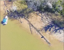  ?? Ben Raines AL.com ?? SHORELINE debris found Jan. 2 in Alabama is believed to be remains of the Clotilda, which delivered 110 slaves in 1860, long after slave imports were banned.