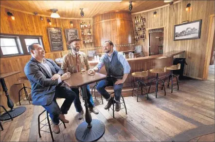  ?? Photograph­s by Ricardo DeAratanha
Los Angeles Times ?? 1933 GROUP operates nine themed bars and restaurant­s in the L.A. area, including Idle Hour, top left. On Idle Hour’s back patio is a replica of L.A.’s long gone Bulldog Cafe. Above, owners Dmitry Liberman, left, Bobby Green and Dimitri Komarov at Idle...