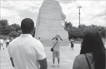  ?? Del Quentin Wilber Los Angeles Times ?? FBI TRAINEES blend in with tourists visiting Washington’s memorial to Martin Luther King Jr. for a class on what Director James B. Comey has called the FBI’s “shameful” history of targeting the civil rights icon.