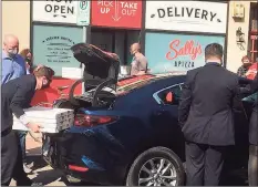  ?? Mark Zaretsky / Hearst Connecticu­t Media ?? Pizzas are picked up from Sally’s Apizza in New Haven Friday for Vice President Kamala Harris and her entourage.