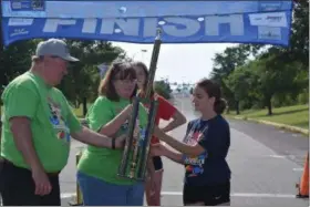  ?? MARIAN DENNIS — MEDIANEWS GROUP ?? Jada Soley is awarded a trophy for finishing first in the masters division of the Pottstown Soap Box Derby Saturday.