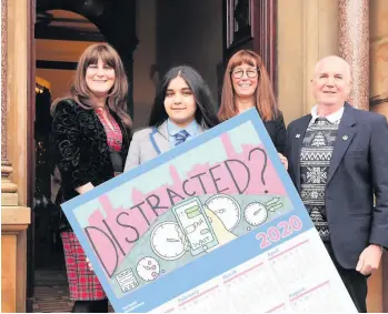  ??  ?? Winner
Iqra Bashir shows off her winning calendar design, joined by councillor­s and school staff