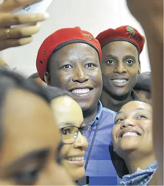  ?? PICTURE: COURTNEY AFRICA ?? ME, MY LEADER AND I: EFF supporters squeeze in for selfies with EFF leader Julius Malema at Stellenbos­ch University yesterday.