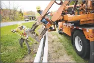  ?? Tyler Sizemore / Hearst Connecticu­t Media ?? State Department of Transporta­tion workers straighten the median guard rail on Interstate 84 in Danbury.