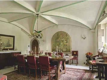  ??  ?? Fig 4 above: The dining room, with its vault added by Tilden. On the far wall is one of two trompe l’oeil flower arrangemen­ts. Fig 5 below: The barbican gate escaped restoratio­n at the hands of Tilden. The main 14th-century gatehouse is visible in the distance