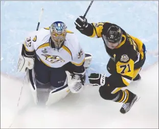  ?? The Associated Press ?? Pittsburgh Penguins forward Evgeni Malkin celebrates in front of Nashville Predators goaltender Pekka Rinne after Penguins defenceman Justin Schultz opened the scoring in the first period of Game 5 of the Stanley Cup Final on Thursday night in...