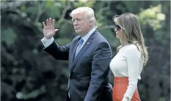  ?? ALEX WONG/GETTY IMAGES ?? U.S. President Donald Trump and first lady Melania Trump walk on the South Lawn prior to their departure from the White House May 19, 2017 in Washington, DC. President Trump is traveling for his first foreign trip to visit Saudi Arabia, Israel,...