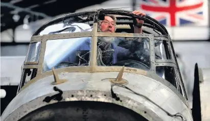  ??  ?? > Dave Payne working in the cockpit of the Avro Lancaster NX611 ‘Just Jane’ which was built in Longbridge