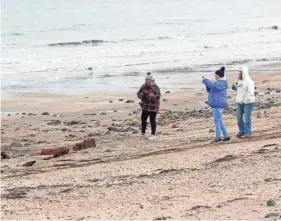  ?? DEB CRAM/SEACOASTON­LINE ?? Visitors to York Short Sands Beach in Maine can catch a glimpse of a pre-Revolution­ary shipwreck that has resurfaced from the sand due to recent storms. The wooden sloop, named Defiance, was built in 1754 and wrecked in 1769 while sailing to Portland.