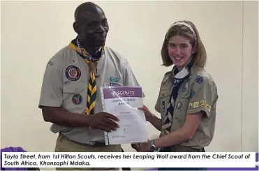  ?? ?? Tayla Street, from 1st Hilton Scouts, receives her Leaping Wolf award from the Chief Scout of South Africa, Khonzaphi Mdaka.