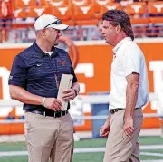  ?? [AP PHOTO] ?? Oklahoma State coach Mike Gundy, right, talks with Texas coach Tom Herman before the start of their game Saturday at Darrell K Royal — Texas Memorial Stadium in Austin.