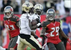  ?? JASON BEHNKEN — THE ASSOCIATED PRESS ?? New Orleans Saints running back Alvin Kamara (41) scores on a 7-yard touchdown run against the Tampa Bay Buccaneers during the first half of an NFL football game Sunday in Tampa, Fla.