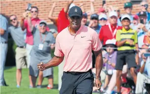  ?? KEVIN C. COX GETTY IMAGES ?? A 25-foot putt for eagle at 18 gave Tiger Woods and the gallery plenty to cheer about at East Lake.