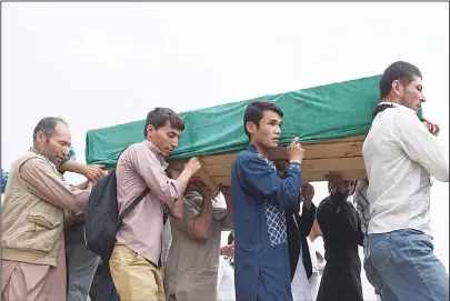  ??  ?? Afghan mourners carry the coffin of one of the 80 people killed in a twin suicide attack, in Kabul, on July 24. Kabul was plunged into mourning on Sunday after the deadliest attack for 15 years killed 80 people and left hundreds maimed, reigniting...