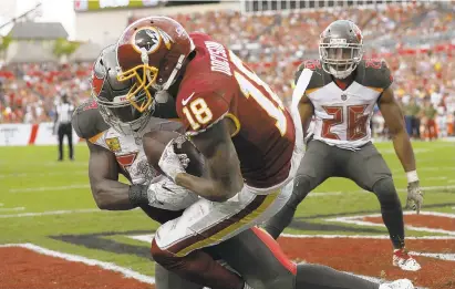  ?? MARK LOMOGLIO/AP ?? Redskins wide receiver Josh Doctson pulls in a pass for the game’s only touchdown as he battles the Bucs’ Lavonte David in the second half.