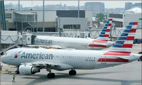  ?? (File Photo/AP/Steven Senne) ?? American Airlines passenger jets prepare for departure July 21 near a terminal at Boston Logan Internatio­nal Airport in Boston.