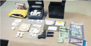  ?? — ABBOTSFORD POLICE FILES ?? Some of the drugs and cash allegedly seized by police last May are shown after officers executed 10 search warrants of cars and residences connected to Corey Jim Perkins.