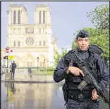  ?? PASCAL LE
SEGRETAIN / GETTY
IMAGES ?? Police surround the Notre Dame Cathedral neighborho­od in Paris on Tuesday after a hammerwiel­ding man attacked a police officer who was guarding the site.