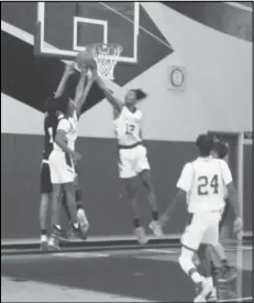  ?? JOHN SANDERS/Valley Press Sports Correspond­ent ?? CRASHING THE BOARD — Players from the Eastside and Palmdale boys basketball teams compete for a rebound during a Golden League game at Eastside High School on Wednesday night. Eastside won the game 70-43.