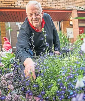  ??  ?? Charlie Forbes tends to the flowers in the garden.