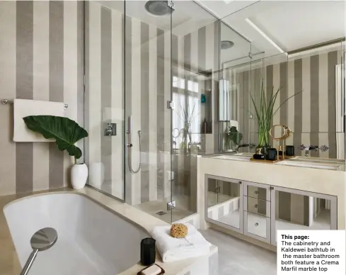  ??  ?? This page:
The cabinetry and Kaldewei bathtub in the master bathroom both feature a Crema Marfil marble top