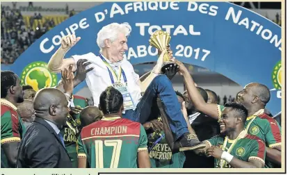  ?? PHOTO: ISSOUF SANOGO/AFP ?? Cameroon players lift their coach Hugo Broos as they celebrate beating Egypt 2-1 in the Afcon final in Gabon on Sunday.