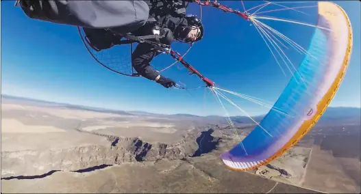  ?? Courtesy Colin Hubbard ?? Colin Hubbard of Taos sails over the Río Grande Gorge during a powered paraglider training flight in summer 2018.