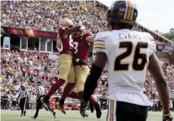  ?? AP ?? FEELING GOOD: BC wide receiver Jaden Williams is congratula­ted by quarterbac­k Dennis Grosel (8) after scoring a touchdown as Missouri defensive back Akayleb Evans looks on during the first half Saturday.