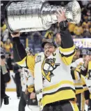  ?? MARK HUMPHREY / AP ?? Pittsburgh Penguins captain Sidney Crosby carries the Stanley Cup after the Penguins defeated the Nashville Predators 2-0.