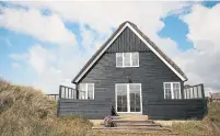  ?? DREAMSTIME ?? Black houses are common in Denmark. In northern Europe, where tar was used as a water sealant, the colour stuck.