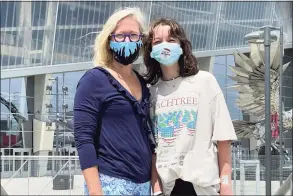  ?? Angie Wang / Associated Press ?? English Norman and her 12-year-old daughter, Jane Ellen Norman, outside Mercedes-Benz Stadium in Atlanta on Tuesday. Jane Ellen and her 14-year-old brother, Owen, were vaccinated Tuesday morning, just after U.S. regulators expanded use of Pfizer’s COVID-19 shot to those as young as 12.