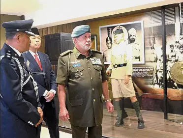  ??  ?? Grim reminder: Sultan Ibrahim taking a tour after opening the Galeri Darurat Bukit Kepong (Bukit Kepong Gallery of the Emergency Period) in Muar, Johor. With him are Deputy Prime Minister Datuk Seri Dr Ahmad Zahid Hamidi and a senior police officer. —...